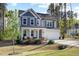 A beautiful two-story home boasts a covered porch, two-car garage, and surrounded by mature trees at 254 W Odell Ln, Zebulon, NC 27597