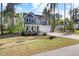 Two-story home featuring a covered porch and a two-car garage, nestled in a serene, wooded neighborhood at 254 W Odell Ln, Zebulon, NC 27597