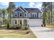 Charming two-story home featuring a covered front porch, two-car garage and manicured lawn at 254 W Odell Ln, Zebulon, NC 27597
