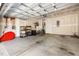 An unfinished garage with storage shelves, bicycles, and overhead door hardware at 254 W Odell Ln, Zebulon, NC 27597