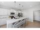 Modern kitchen featuring a large island with seating, stainless steel appliances, and white cabinetry at 254 W Odell Ln, Zebulon, NC 27597