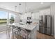 Bright kitchen featuring stainless steel appliances, white cabinets, and a large island with seating at 254 W Odell Ln, Zebulon, NC 27597