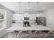 Modern kitchen featuring a large island with seating, stainless steel appliances, and white cabinetry at 254 W Odell Ln, Zebulon, NC 27597