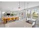 Open-concept living space with large windows, modern lighting, and inviting dining area and comfortable seating at 254 W Odell Ln, Zebulon, NC 27597