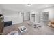 Neutral playroom with large rug, plush seating and built in shelving at 254 W Odell Ln, Zebulon, NC 27597