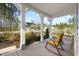 Inviting front porch with rocking chairs and scenic views of the neighborhood and surrounding trees at 254 W Odell Ln, Zebulon, NC 27597