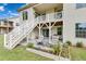 Inviting backyard patio with white stairs leading to a second-story deck and manicured landscaping at 2613 Beckwith Rd, Apex, NC 27523