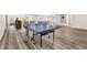 Finished basement with a ping pong table, media center, and stylish decor at 2613 Beckwith Rd, Apex, NC 27523