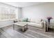 Cozy basement sitting area with sofa, coffee table, and bright window, creating a welcoming space at 2613 Beckwith Rd, Apex, NC 27523