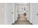 An open door reveals an inviting, bright bathroom with modern fixtures and design at 2613 Beckwith Rd, Apex, NC 27523
