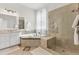Well-lit bathroom with a glass-enclosed shower, soaking tub, and double sink vanity at 2613 Beckwith Rd, Apex, NC 27523