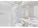 Modern bathroom with a glass-enclosed shower, sleek white tile, and a stylish pedestal sink at 2613 Beckwith Rd, Apex, NC 27523