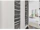Open closet reveals shelving and a view into a neutrally-decorated living space with a couch at 2613 Beckwith Rd, Apex, NC 27523