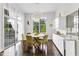 Bright dining room with modern light fixture, large windows, and sleek furniture perfect for entertaining at 2613 Beckwith Rd, Apex, NC 27523