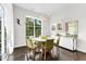 Bright dining room with modern light fixture, large windows, and sleek furniture perfect for entertaining at 2613 Beckwith Rd, Apex, NC 27523