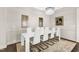 This stylish dining area features sleek furniture, artwork, and a decorative rug on dark floors at 2613 Beckwith Rd, Apex, NC 27523