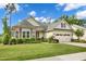 Charming home features a manicured lawn, beautiful landscaping, and an attached two-car garage at 2613 Beckwith Rd, Apex, NC 27523
