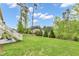 Lush lawn view featuring a well-maintained yard, trees, and a patio at 2613 Beckwith Rd, Apex, NC 27523
