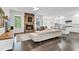This inviting living space includes a stone fireplace, an L-shaped sofa, and an open-concept kitchen at 2613 Beckwith Rd, Apex, NC 27523