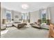 Bright main bedroom featuring multiple windows, neutral color scheme, and stylish furniture at 2613 Beckwith Rd, Apex, NC 27523