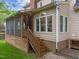 Back exterior view showcasing a screened porch and a well-maintained yard at 2613 Hiking Trl, Raleigh, NC 27615