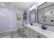 Modern bathroom with double vanity, decorative floor tiles, and a glass-enclosed shower at 2613 Hiking Trl, Raleigh, NC 27615