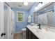 Charming bathroom with blue walls, wood-look floors, and a shower with curtain at 2613 Hiking Trl, Raleigh, NC 27615