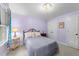 Cozy bedroom featuring a chandelier, neutral carpet, and complementary lilac painted walls at 2613 Hiking Trl, Raleigh, NC 27615