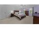 Bright bedroom featuring textured wall, a ceiling fan, and carpet flooring at 2613 Hiking Trl, Raleigh, NC 27615