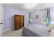 Comfortable bedroom with a large wardrobe and natural light coming in from two windows at 2613 Hiking Trl, Raleigh, NC 27615