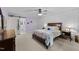 Comfortable bedroom features a ceiling fan, textured wall, and ensuite bathroom with sliding barn door at 2613 Hiking Trl, Raleigh, NC 27615