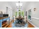 Sunlit breakfast nook with a skylight, hardwood floors, and views of the lush greenery at 2613 Hiking Trl, Raleigh, NC 27615