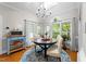 Sunlit breakfast nook with a skylight, hardwood floors, and views of the lush greenery at 2613 Hiking Trl, Raleigh, NC 27615
