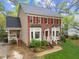 Charming two-story home with brick and siding exterior, lush landscaping, and a well-manicured lawn at 2613 Hiking Trl, Raleigh, NC 27615