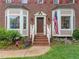 Close up of the front entrance featuring a brick facade, bay windows, and a welcoming entryway at 2613 Hiking Trl, Raleigh, NC 27615