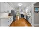 Bright kitchen with white cabinets, stainless steel appliances, and granite countertops at 2613 Hiking Trl, Raleigh, NC 27615