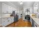 Bright kitchen with white cabinets, stainless steel appliances, and granite countertops at 2613 Hiking Trl, Raleigh, NC 27615