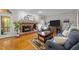 Cozy living room featuring a brick fireplace, hardwood floors, and comfortable blue furnishings at 2613 Hiking Trl, Raleigh, NC 27615
