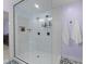 Walk-in shower featuring a dual shower head and a built-in seat at 2613 Hiking Trl, Raleigh, NC 27615