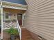 Charming side entrance features a cozy porch, perfect for relaxing and enjoying the outdoors at 2613 Hiking Trl, Raleigh, NC 27615