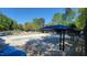 Community swimming pool, covered seating area and sundeck chairs offer respite to residents on hot summer days at 2613 Hiking Trl, Raleigh, NC 27615