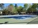 Brightly painted tennis courts offer space for neighborhood athletes to practice or play matches at 2613 Hiking Trl, Raleigh, NC 27615