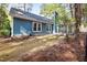 Backyard with a view of the home and the sunroom at 2709 Hidden Hollow Dr, Durham, NC 27703