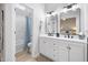 Modern bathroom with double vanity, framed mirrors, and a shower-tub combination at 2709 Hidden Hollow Dr, Durham, NC 27703