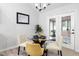 Cozy dining area with modern table, chairs, and a plant near door at 2709 Hidden Hollow Dr, Durham, NC 27703
