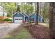 Charming blue home with an attached garage and well-manicured landscaping at 2709 Hidden Hollow Dr, Durham, NC 27703