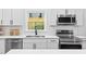 A view of the modern kitchen, featuring stainless appliances and white countertops at 2709 Hidden Hollow Dr, Durham, NC 27703