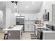 Renovated kitchen with stainless steel appliances, pendant lighting, and white cabinets at 2709 Hidden Hollow Dr, Durham, NC 27703