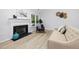 Bright living room features a fireplace, modern decor, light wood floors, and large windows at 2709 Hidden Hollow Dr, Durham, NC 27703