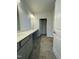 Bathroom features a double vanity with gray cabinets, quartz countertops, and tile flooring at 288 Olivia Crossing Ct # 10, Four Oaks, NC 27524